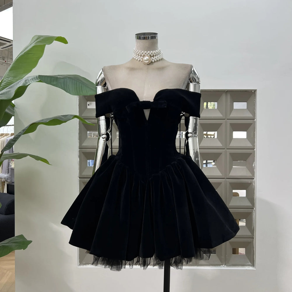 Black velvet dress on a mannequin against a light background