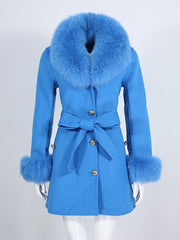 Blue coat with fur trim on a mannequin against a white background