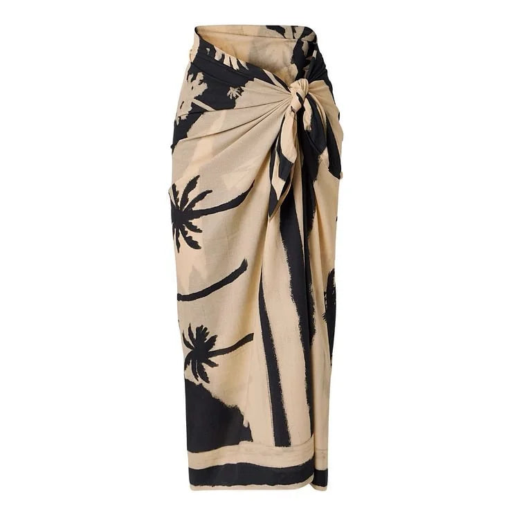 Beige and black palm print sarong tied at the waist