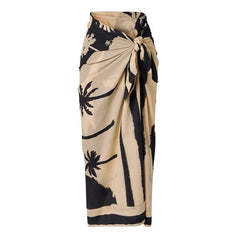 Beige and black palm print sarong tied at the waist