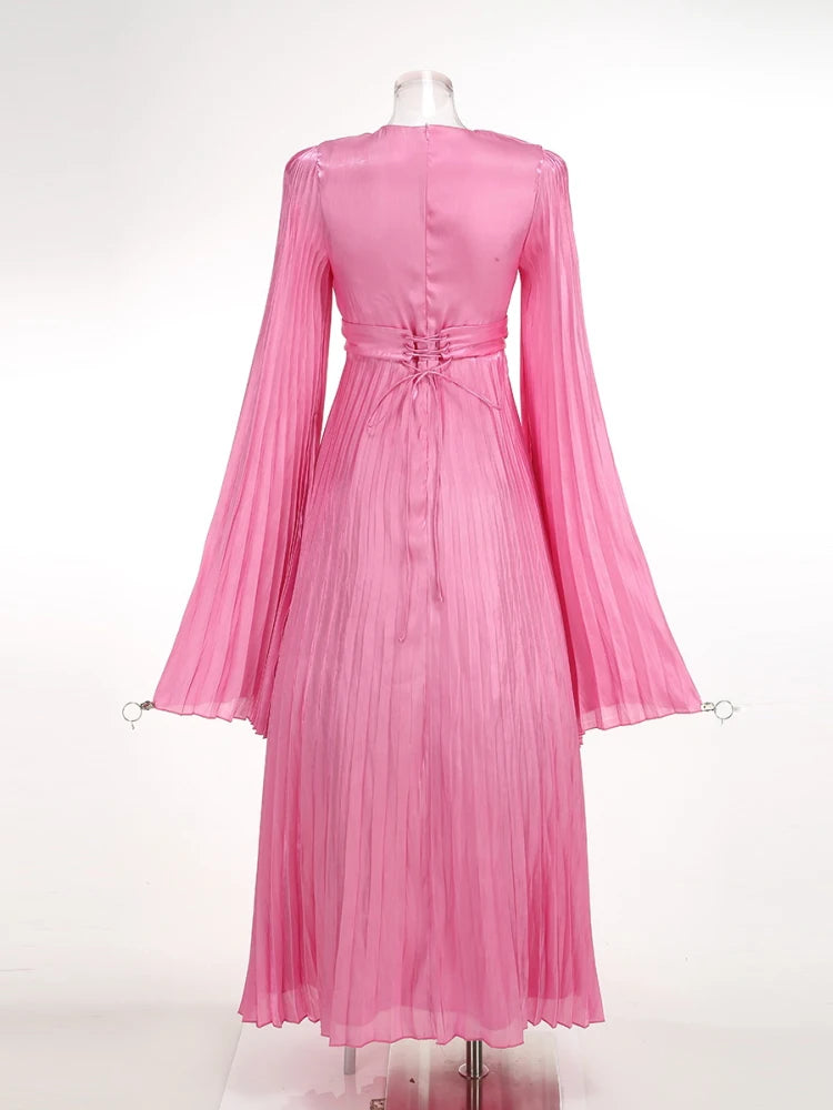 Pink pleated dress on a mannequin against a white background