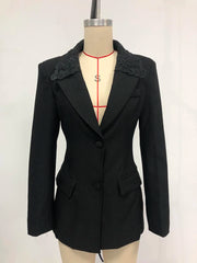 Black blazer with lace details on a mannequin against a white background