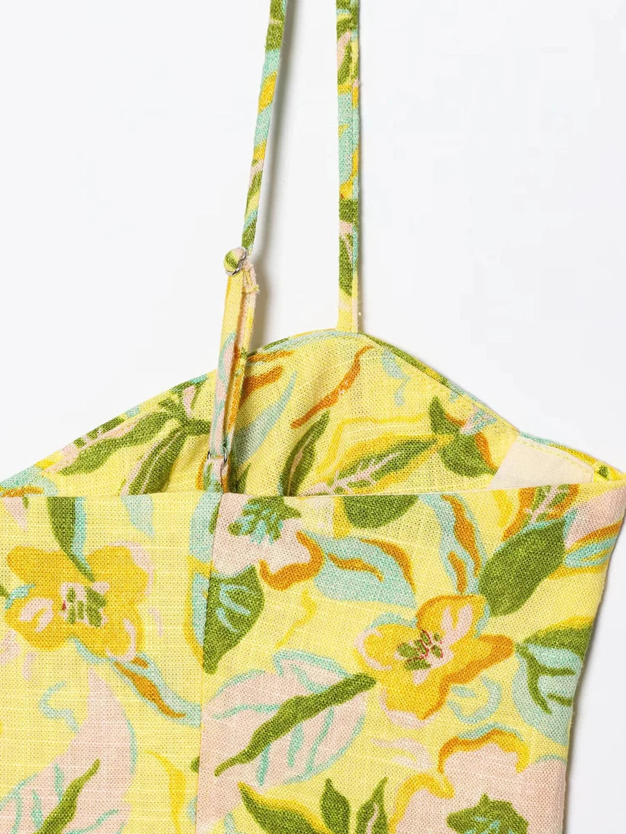 Floral-patterned bag with a yellow and green design on a white background
