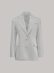 Light gray blazer with lace trim on a light gray background