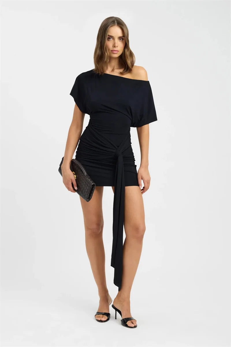 Woman wearing a black off-shoulder dress on a white background