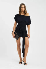 Woman wearing a black off-shoulder dress on a white background