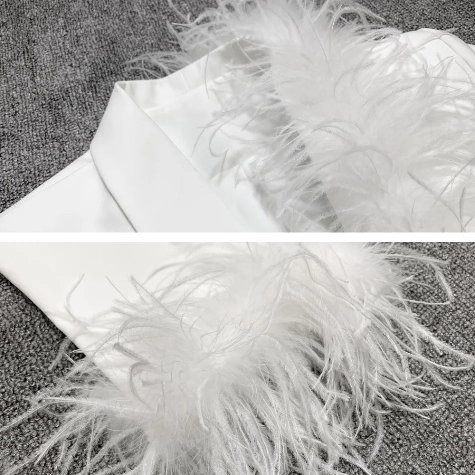Close-up of a white feathered item on a textured surface