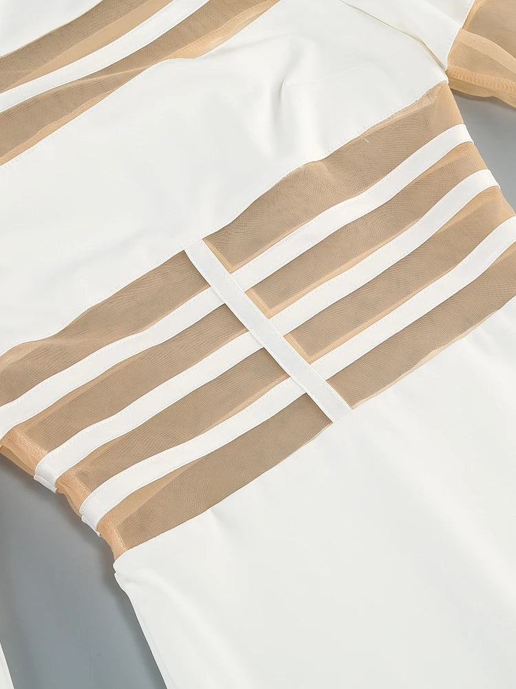 Close-up of a white garment with beige stripes on a gray background