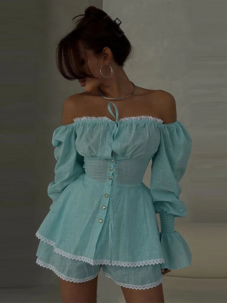 Woman wearing a light blue off-shoulder dress with puffed sleeves against a neutral background