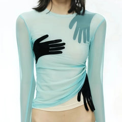 Light blue long-sleeve top with black gloves on a white background