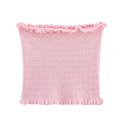Pink textured pillow with ruffled edge on a white background