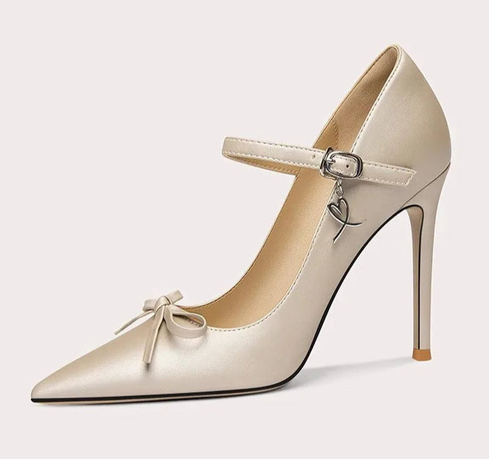 Beige high-heeled shoe with a bow detail on a white background