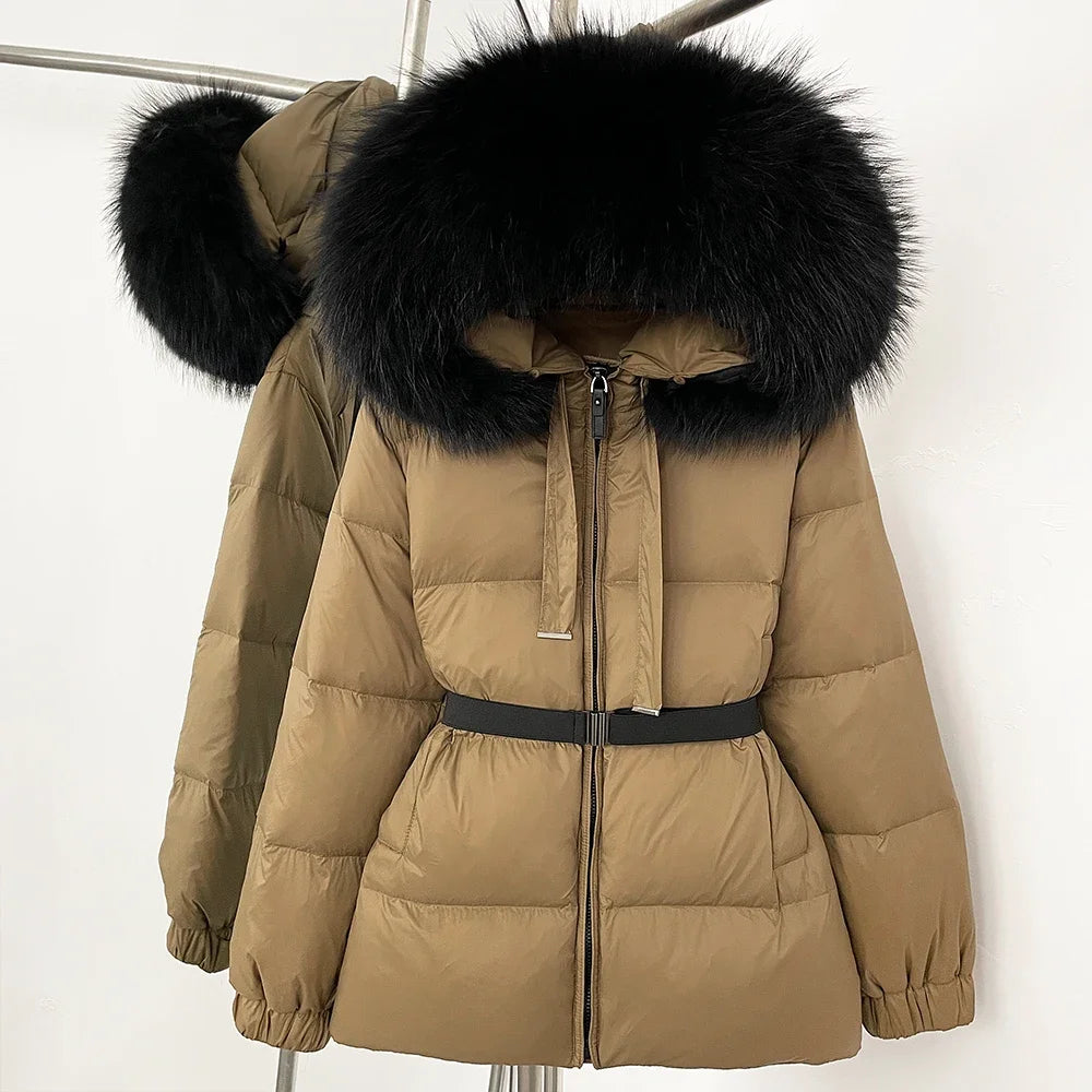 Beige puffer jacket with black fur hood on a white background