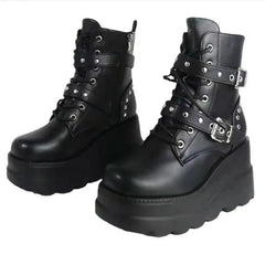 Black platform boots with buckles and straps on a white background