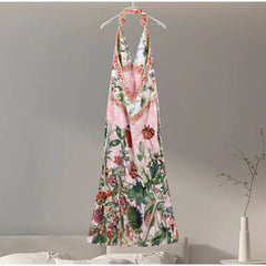 Floral dress hanging on a hanger against a neutral background
