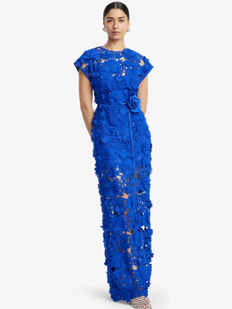 Detailed view of the floral appliqu� on a blue maxi dress.