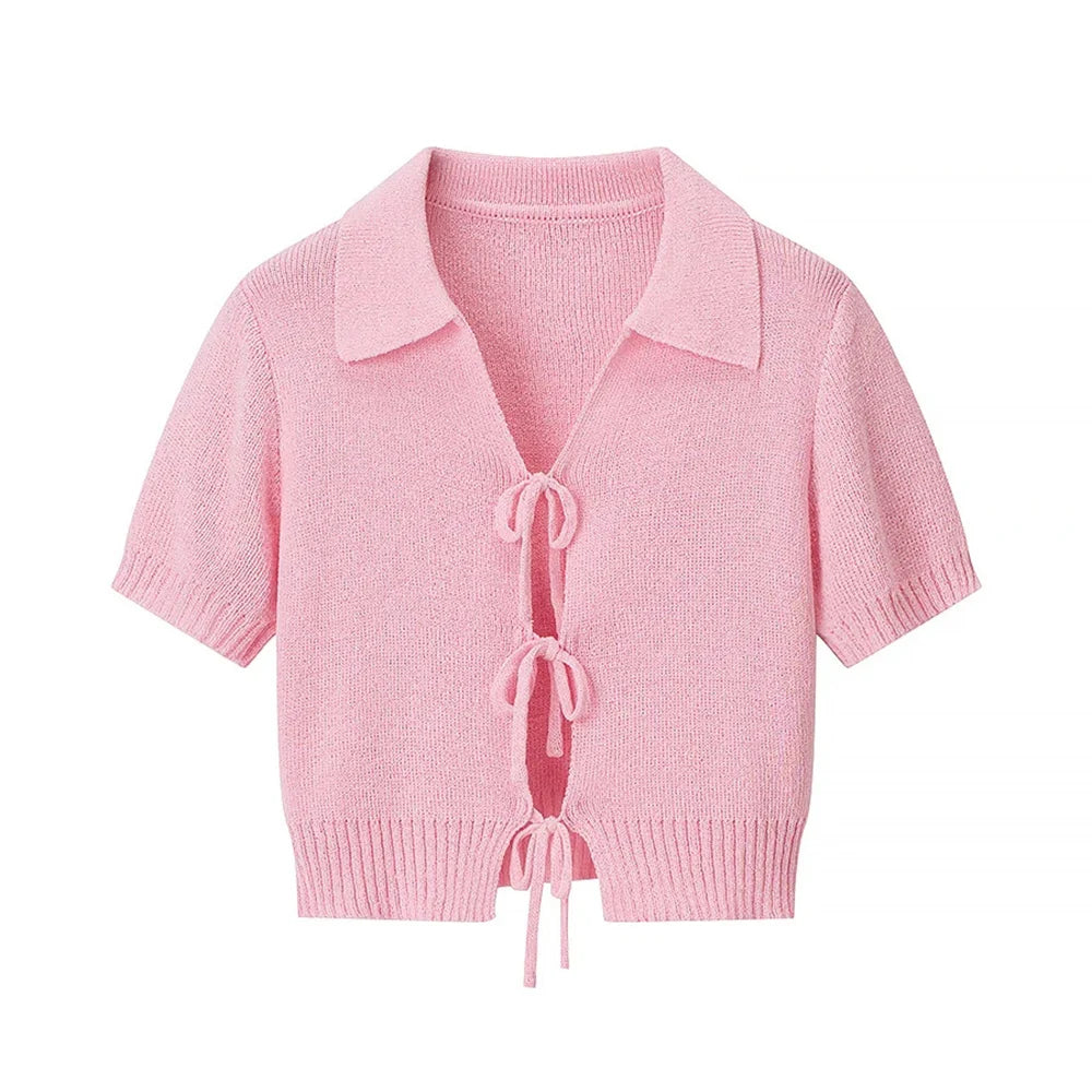 Pink knitted cardigan with a collar on a white background