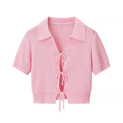 Pink knitted cardigan with a collar on a white background