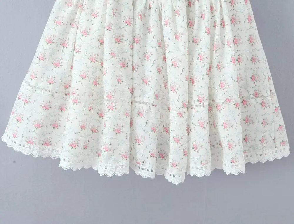 White lace skirt with pink floral pattern on a gray background