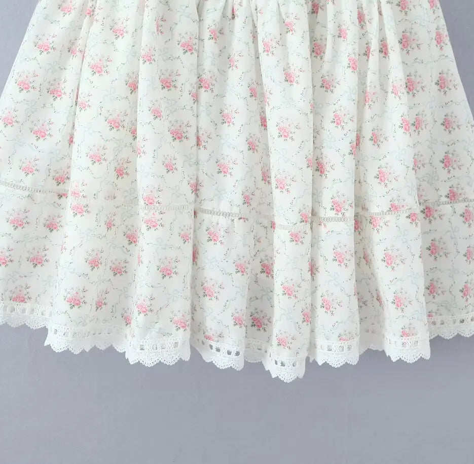 White lace skirt with pink floral pattern on a gray background