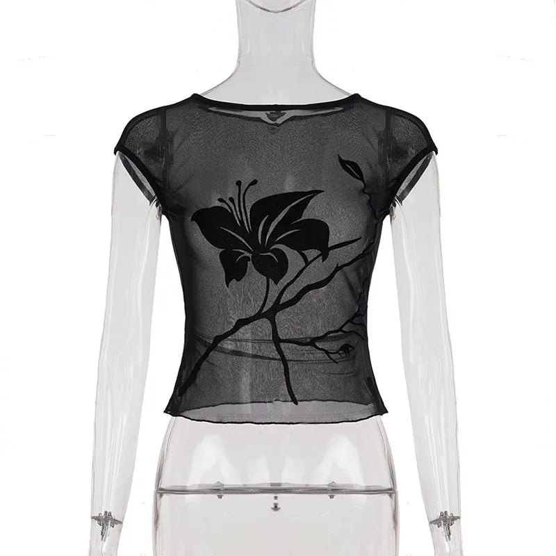 Black sheer top with butterfly design on a mannequin against a white background