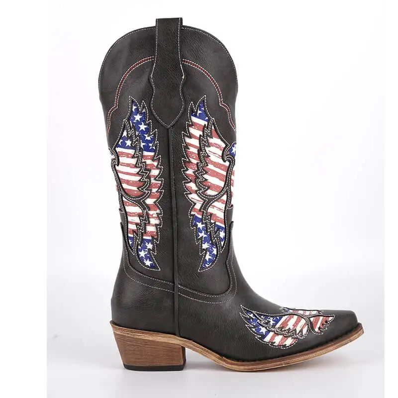 Side view of black embroidered wing western boots with pointed toe