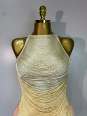 Mannequin wearing a beige ruched dress against a plain background