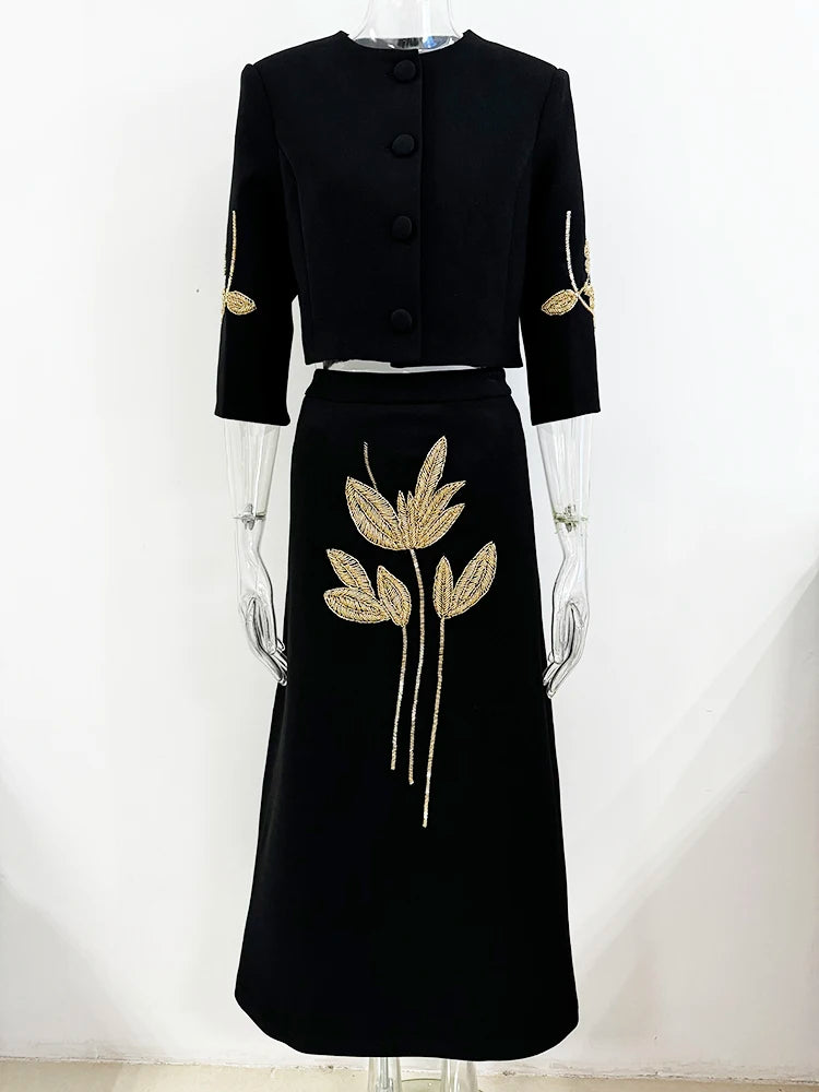 Beaded cropped jacket and midi skirt suit displayed on mannequin