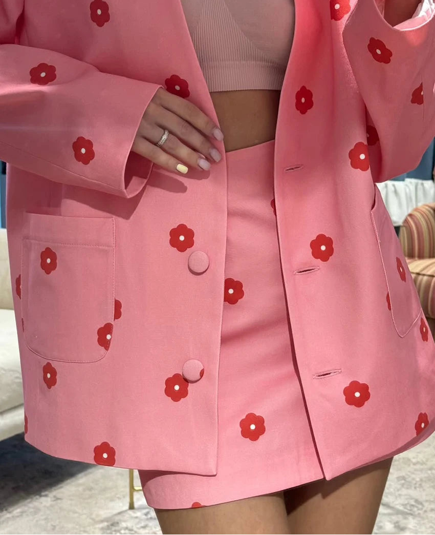 Pink outfit with red floral patterns