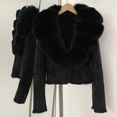 Black faux fur jacket on a hanger against a white background