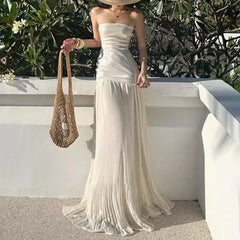 Strapless sequin bodice maxi dress with flowing pleated skirt and straw hat