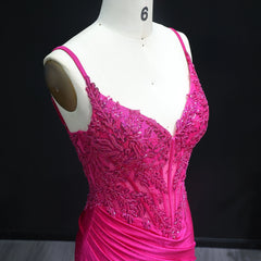 Pink beaded dress on a mannequin against a black background
