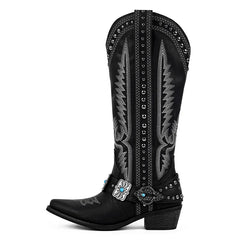 Black cowboy boot with intricate silver embroidery and a turquoise buckle on a white background