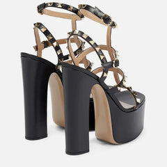 Black platform high-heeled sandals with gold accents