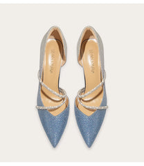 Pair of blue pointed-toe shoes with strappy design on a light gray background
