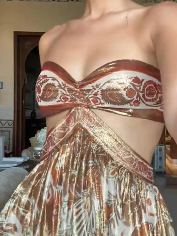 Partial view of a person wearing a patterned strapless top and skirt.