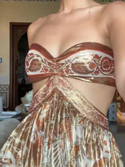 Partial view of a person wearing a patterned strapless top and skirt.