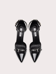 Pair of black high-heeled shoes with decorative straps on a white background