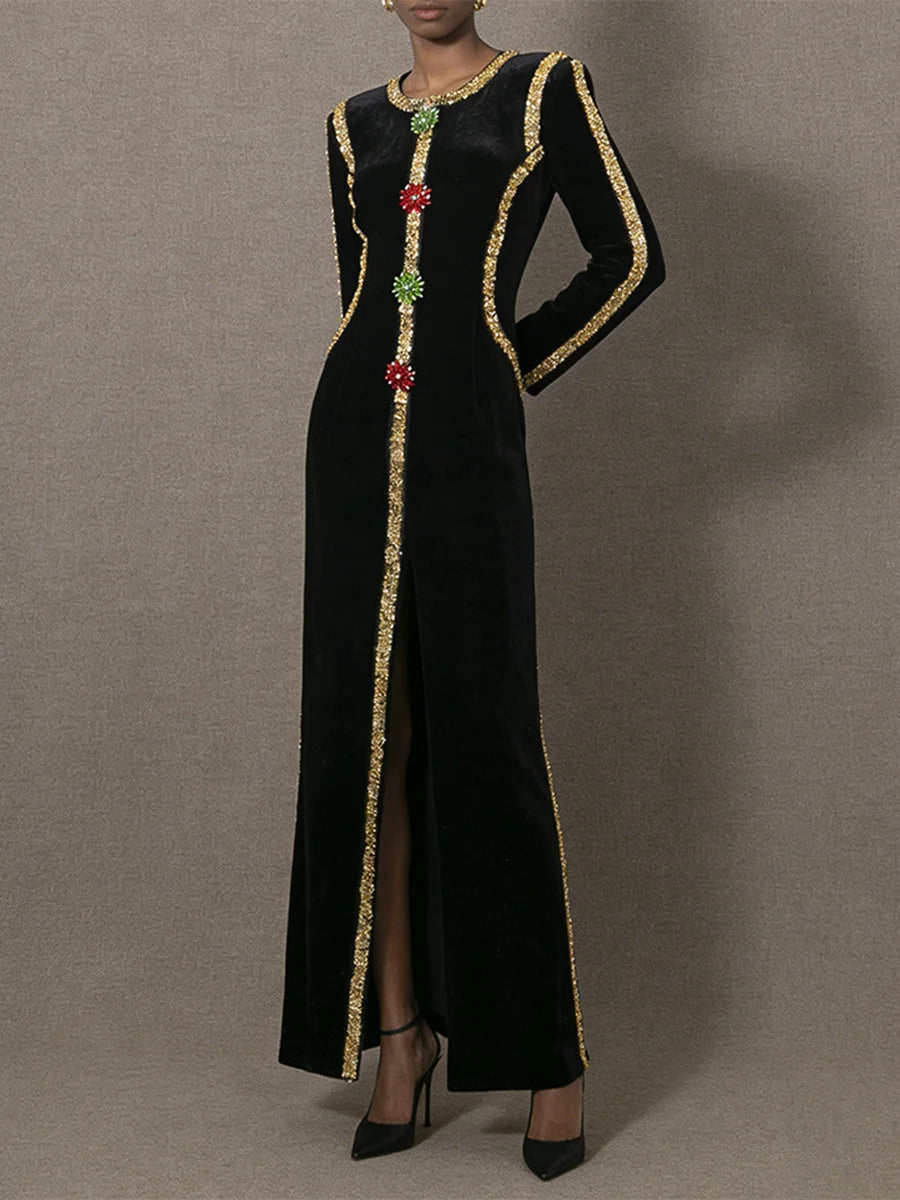 Black dress with gold trim and colorful beads on a gray background