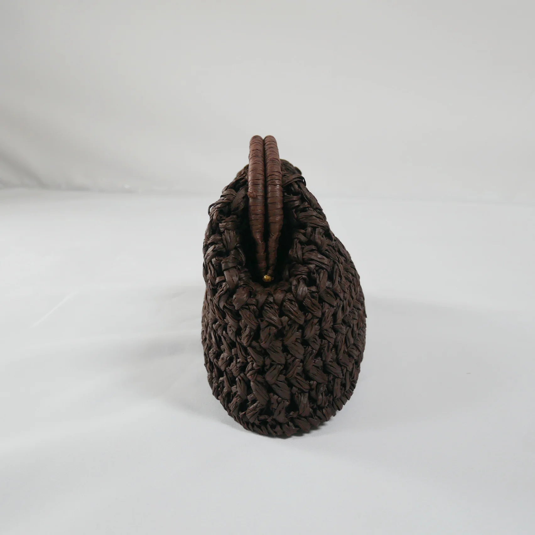 Coffee woven handbag on a white background