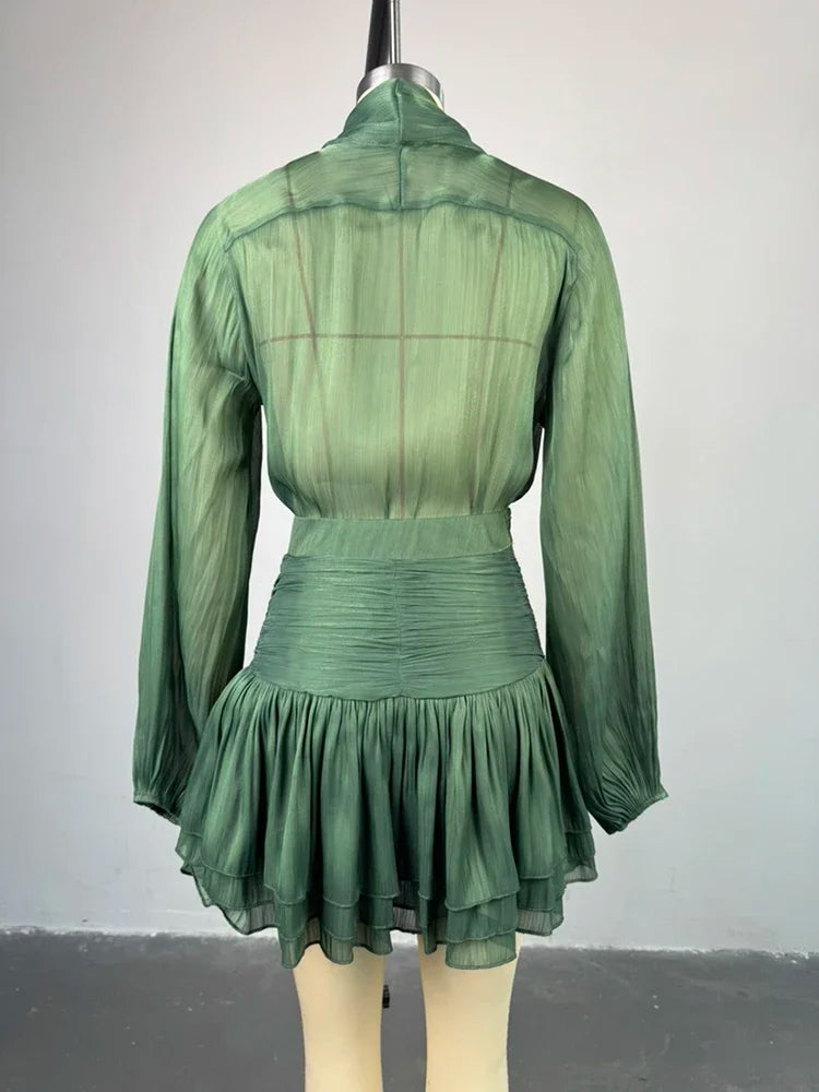 Green dress on a mannequin against a plain background