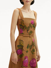 Woman wearing a brown dress with floral patterns on a white background