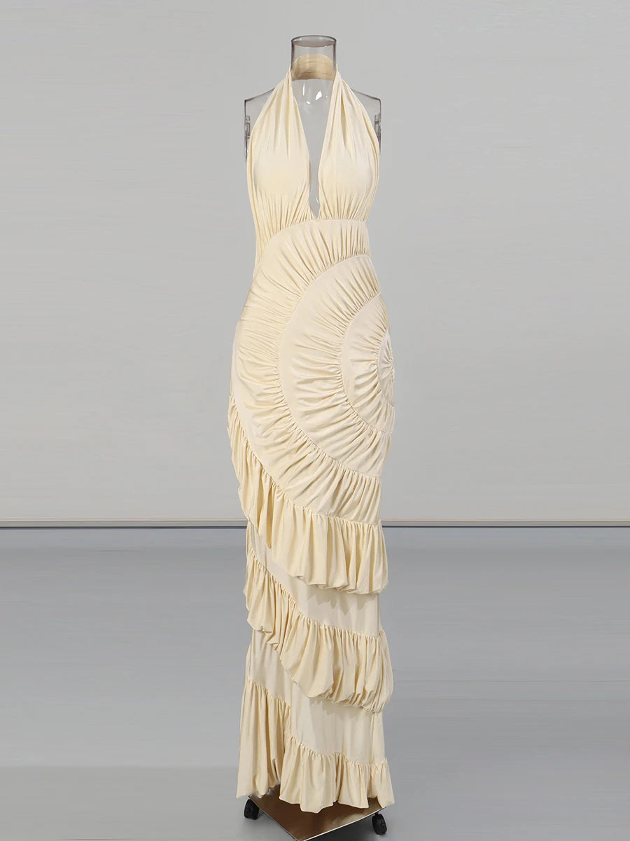 Beige halter neck dress on a mannequin against a gray background