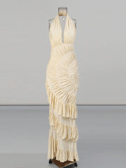 Beige halter neck dress on a mannequin against a gray background