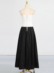 White top and black skirt on a mannequin against a white background