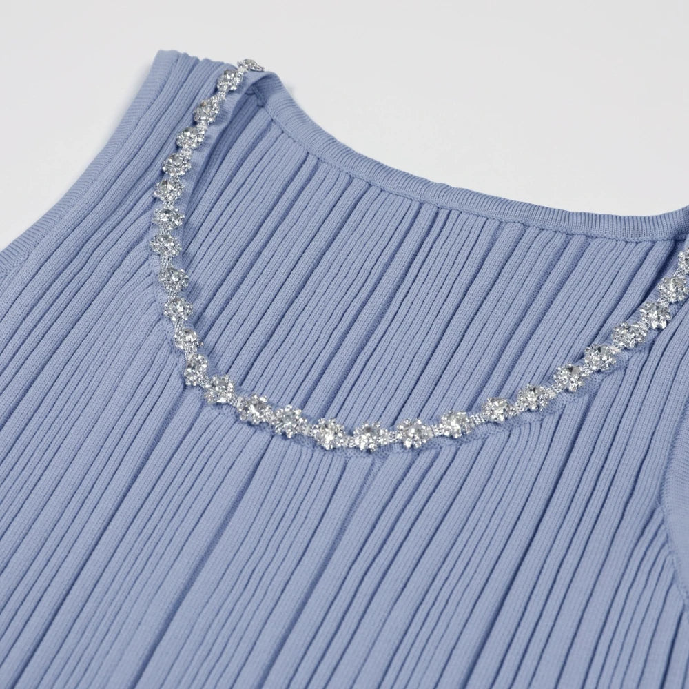 Light blue ribbed sweater with decorative silver trim on a light gray background