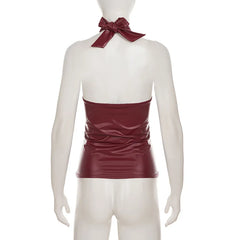 Mannequin wearing a burgundy halter top with a bow tie on a white background