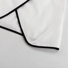 White shirt with black trim on a light gray background
