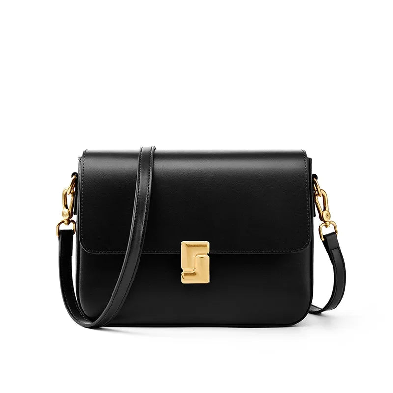 Black handbag with gold clasp on a white background