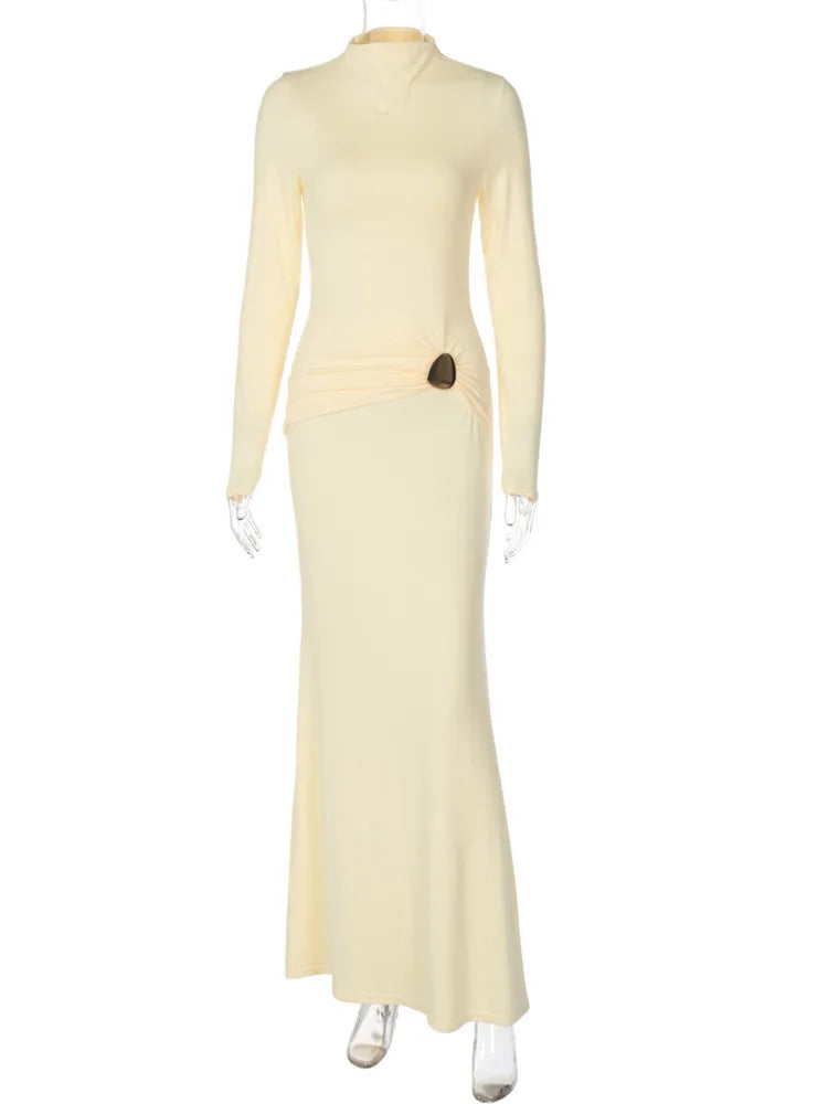 Long light yellow dress on a mannequin against a white background